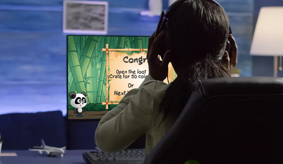 Child playing game in front of a monitor