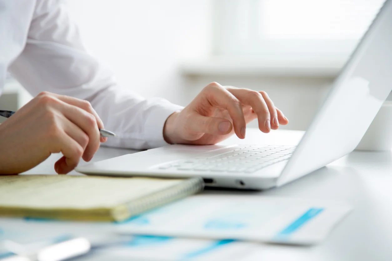 Close-up of hands of business man typing on a laptop. stock photo