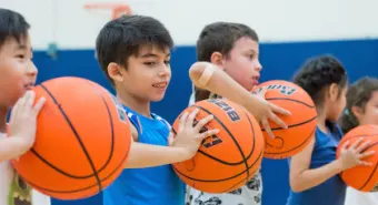 a group of kids holding basketballs