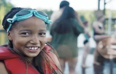 girl with a life jacket smiling