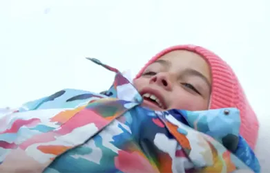 a girl making a snow angel