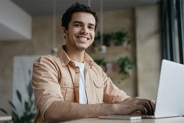 a young man sitting in front of a computer