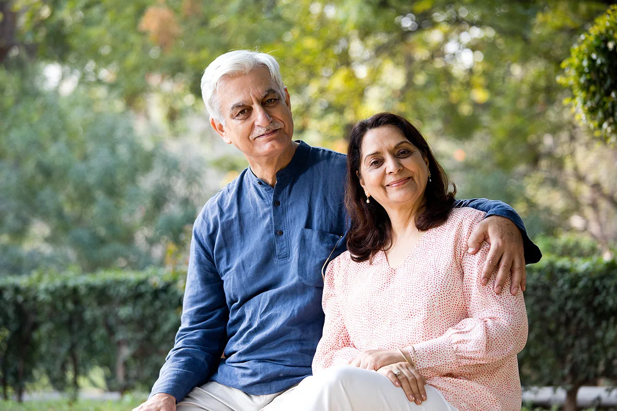 an elder indian man and woman, smiling